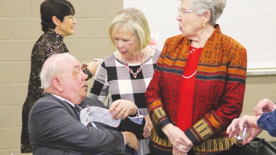 A true person of the people, Moppy Miller (middle) talks to a former Citizen of the Year, Ed Komandosky, and a former Woman of the Year, Susan Komandosky. Photo by Jason Hennington