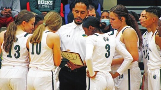 First year Taylor girls’ basketball coach Lawrence Bailey talks strategy with his team earlier this season. Photo by Matt Hooks