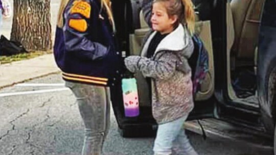 Members of the Granger High School girls basketball team open doors for younger students at the start of the school day Jan. 14. Facebook / Granger ISD