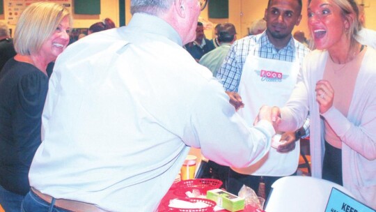 People stop by the table of Superintendent Devin Padavil (center) at the Annual Food Dudes Event in Taylor Jan. 29 to benefit the Taylor Educational Enrichment (TEE) Foundation, which in turns benefits Taylor ISD classrooms.