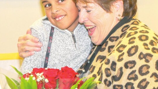 Taylor ISD school board member Marilyn Tennill is presented with a bouquet of roses during the school board meeting Jan. 24 from her grandson, Carter, on behalf of Naomi Pasemann Elementary School.