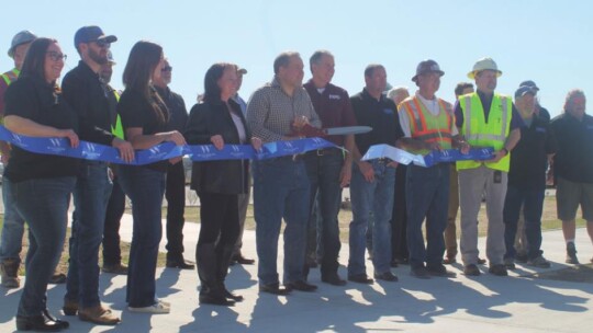 Russ Boles, Williamson County Precinct 4 commissioner, cuts the ribbon marking the completion of improvements to the Williamson County Expo Center in Taylor Feb. 11.