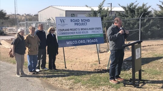 Attending the Coupland street project groundbreaking were, left to right, Coupland Alderwomen Susan Garry and Karen Marosko, Mayor Jack Piper, Mayor pro tem Barbara Piper, and, speaking, Commissioner Russ Boles. Photo by Ted Wittliff