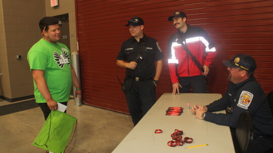 Donovan Palacios (left) visits with the Taylor Fire Department table at the Trades Day Career Fair at the Williamson County Expo Center in Taylor March 2. Talking with Palacios are firefighters Cody Kraemer, Caleb Anchors and Tim Davis. Photos by Fernando Castro