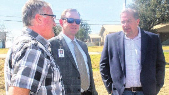 Commissioner Russ Boles (right) talks with Thrall Independent School District Superintendent Tommy Hooker (middle) and Mayor Troy Marx in Thrall Feb. 28.