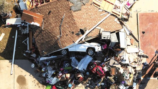 A car was flipped and damaged along with a home in Granger Monday night. Photo by Jake Ferrigan, Aerotract Geospatial