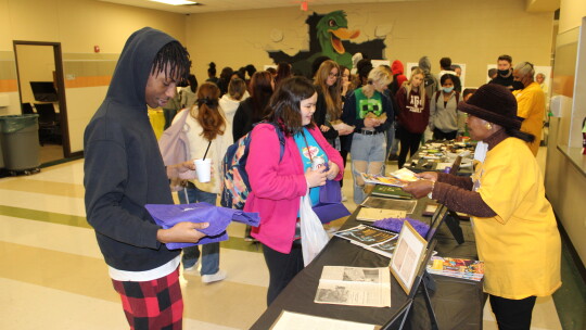 Jennifer Harris shares memorabilia about James Lee Dickey, while Renee Ross visits with students about items that were invented by African Americans. Photos by Tim Crow