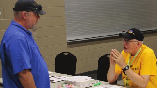 John Kiracofe from the Austin Disaster Relief Network (right) helps check in Robert Garrett of Round Rock, who was impacted by last week’s tornado.