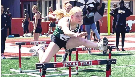 Emma Whitsel warms up during the Texas relays in the event that would mark her place in school history. Courtesy Photo Earven Flowers