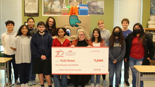 Several of Vicki Rowe’s scholars congratulate her on being named a finalist for the HEB Excellence Award. Rowe says her scholars give her purpose to get up in the morning with a smile on her face. Photo by Tim Crow