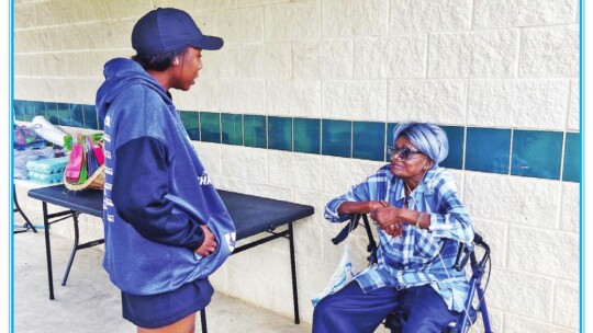 Nekoye Anderson (left) takes a moment to visit with Ruth Tanksley at the annual Hood Hunt in south Taylor.