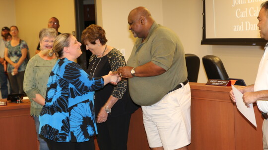 Taylor Middle School counselor Candice Martin is thanked by school board vice president Shorty Mitchell for her efforts in saving a student who was choking. Photo by Tim Crow