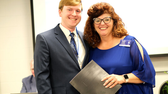 Rotary Club of Taylor president Tia Rae Stone presents the 2022 Bunnell-Rotary Academic Scholarship for $6,000 to Taylor High School graduating senior Trey Boles during a May 2 banquet in Taylor. Boles is the son of Renee Boles and Jarrell Boles.hoto by Richard Stone