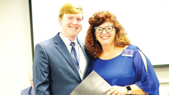 Rotary Club of Taylor president Tia Rae Stone presents the 2022 Bunnell-Rotary Academic Scholarship for $6,000 to Taylor High School graduating senior Trey Boles during a May 2 banquet in Taylor. Boles is the son of Renee Boles and Jarrell Boles.