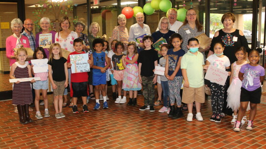 Representatives from the Williamson County Retired Teachers Association meet their hosts at TH Johnson Elementary before going to kindergarten classrooms to read stories to students.