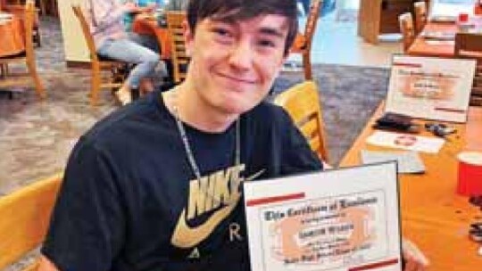 Valedictorian Damien Wilson is pictured with his certificate of excellence from Hutto ISD May 23.