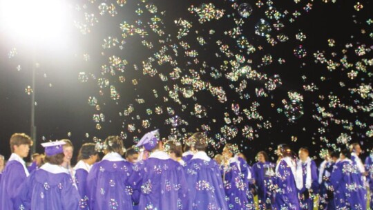 Bubbles fill the sky over Tiger Stadium during high school graduation celebrations in Thrall May 27. Photo by Fernando Castro