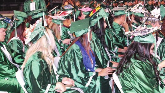 Taylor graduates wait to hear their name called for the final time as high schoolers. Photo by Matilda Rydell