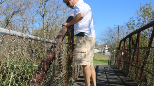 David Legere stands on the bridge that Dr. James Lee Dickey helped get built in 1940 and looks over into Bull Branch Creek in this 2017 photo. Photo by Jason Hennington