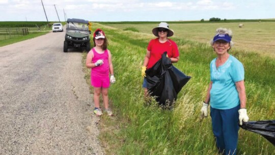 The Rohlack family picks up trash along their county road during Coupland Clean-Up Day. From left are Amelia Cotterill, Stephanie Rohlack and LaVerne Rohlack, Cotterill’s grandmother.