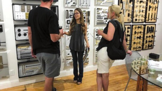 Jessica Mason shows high-end residential hardware to guests.