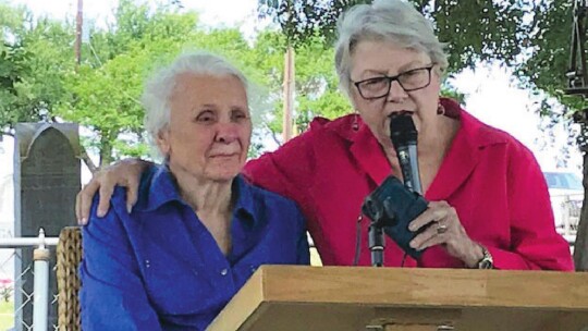 Sandy Murphree (right), Elgin Historical Association president, praises Charlene Hanson for all her help to the Elgin Depot Museum during a ceremony at Type Church near Coupland May 14.