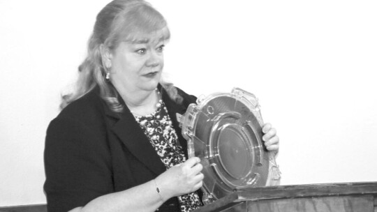 Michelle Glaze shows one device where semiconductor chips are used during the Rotary Club of Taylor’s meeting June 2. Photo by Jason Hennington