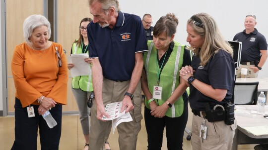 John-Michael Keyes (second from left) goes over training details with Superintendent Celina Estrada Thomas (far left) and others during exercises at Hutto ISD June 8-9. Facebook / Hutto ISD