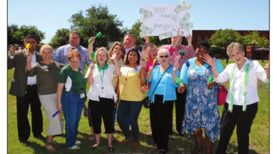 Moppy Miller (center left) joins Naomi Pasemann (far right) and other TEE Foundation supporters in 2016 as Mallard Mania grants were awarded to teachers at Legacy Early College High School.