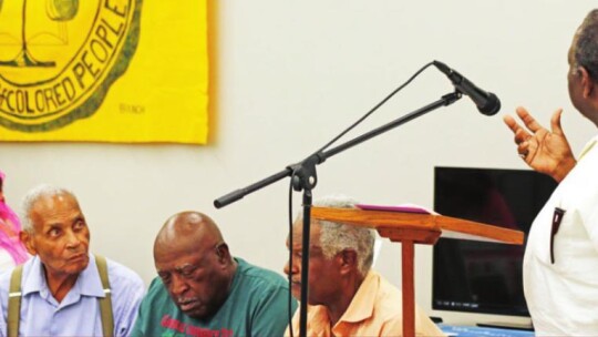 Pastor Larry Caldwell (right) explains the significance of the NAACP and the role the organization played in Taylor in the 80s and 90s. Photo by Jason Hennington