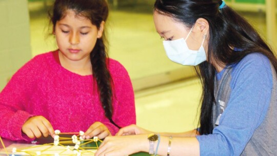 Rebecca Xu (right) and Anitzel Morales work to design and build a rocket ship as part of the Samsung Day of Service.