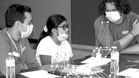 (From left) Samir Ahmadyar, Sophia Salazar and Dimitri Winkeler brainstorm about the next step in their pasta structure. Photos by Jason Hennington