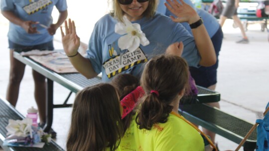 Counselor Greta Hutmacher gives young campers a high-five following their skit. Photos by Matt Hooks