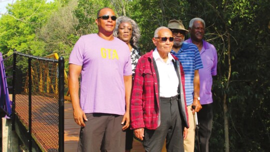 Mayor Pro Tem Gerald Anderson (left) stands with former O.L. Price students (from left) Doris Corely, Ernest Rector, Raymond White Jr. and Rev. James Davis near the Dickey bridge.