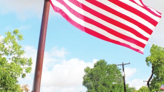 Taylor Fire Department’s Lieutenant Brandon Sanders raises the American flag at Murphy Park in Taylor July 4. Photo by Fernando Castro