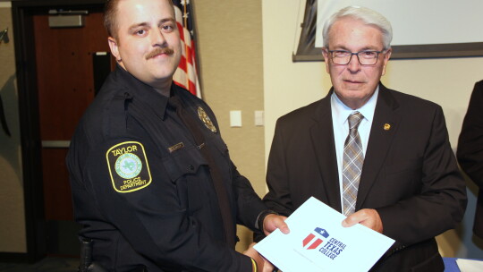 Davis Golden, of the Taylor Police Department, receives congratulations from Jim Yeonopolus, Central Texas College chancellor, during the Central Texas College Police Academy graduation ceremony earlier this summer.   Courtesy photo