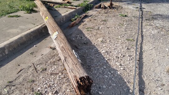 A damaged pole lays on the ground in Granger July 3 after an accident. Photo by Monica Stojanik