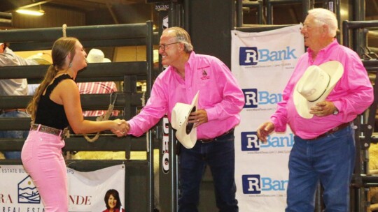 Taylor Rodeo Association members Keith Hagler (left) and John Carter congratulate Mallory McDaniel of Rockdale on being chosen as a recipient for a $5,000 scholarship from the association.