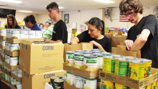 Seth Fluker, Savannah Coy, Matt Aplin, Christina Combs, Jennifer Sabrsula and Luke Schneider volunteer at Shepherd’s Heart Food Pantry and Community Ministries in Taylor July 21 as part of an organized volunteer opportunity for Samsung Austin Semiconductor.