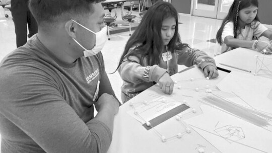 Tiffany Zhang, working with students to make maracas and tambourines. Courtesy photo / Samsung Austin Semiconductor