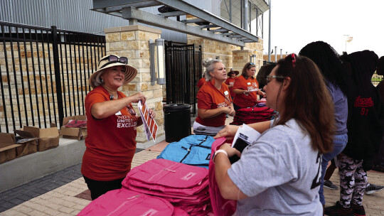 Superintendent Celina Estrada helps give away backpacks and school supplies for Hutto Independent School District parents and students at Hutto Memorial Stadium in Hutto Aug. 6. Hutto ISD has Meet the Teacher nights this week ahead of the first day of school next Monday, Aug. 15.