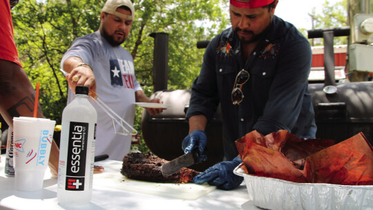 Geraldo and Fernando Reyes slice some brisket at the Taylor International Barbecue Cookoff in Taylor Aug. 20. Photos by Fernando Castro