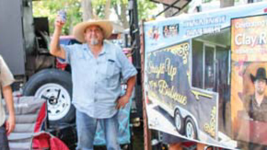 Competitors raise a toast to Clay Raesz during a tribute at the Taylor International Barbecue Cookoff in Taylor Aug. 20.