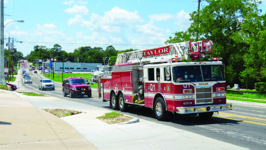 Members of the Taylor Fire Department drive a local fire truck in the funeral processional for Robert Whitmore. Courtesy photos