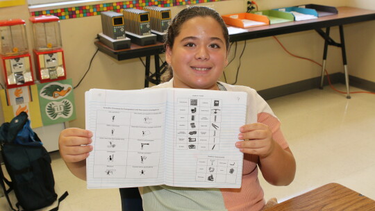 Amyia Vasquez organizes charts and other resources in her Interactive Science Notebook.