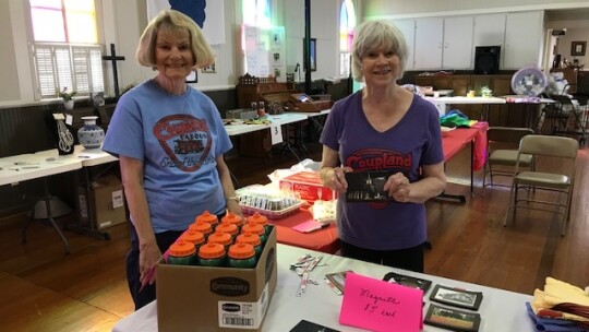 Coupland Civic Organization board members Barbara Piper and Judy Downing prepare for a past Choo Choo Fest silent auction. Photo by Susan Garry