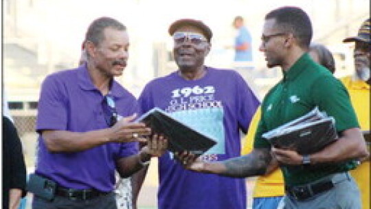 Edward Elder (left), son of O.L. Price head football coach the late Bud Elders, accepts a plaque recognizing his father’s state championship team from Taylor ISD Superintendent Devin Padavil. Photo by Catherine McGary