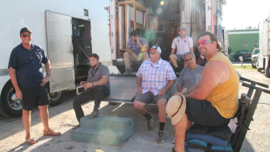 Crew for the TV series “Walker” takes a break Sept. 20 near Louie Mueller Barbecue