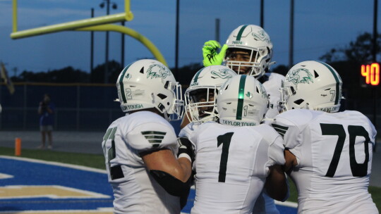 Anderson and Richardson celebrate Anderson’s touchdown with teammates Chris Schroeder (left), Ryan Valdez and Harrison Tate. Photo by Evan Hale 