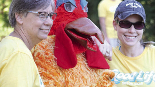 At last year’s event, the Good Life mascot finds time to pose with runners before the big race. Photo by Jason Hennington